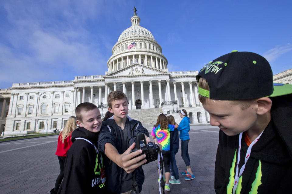 Eighth-grade students from Highland Middle School in La Grange, Ill., take photos as they visit the Capitol in Washington, Monday morning, Oct. 14, 2013, as a partial government shutdown enters its third week. (AP Photo/J. Scott Applewhite)