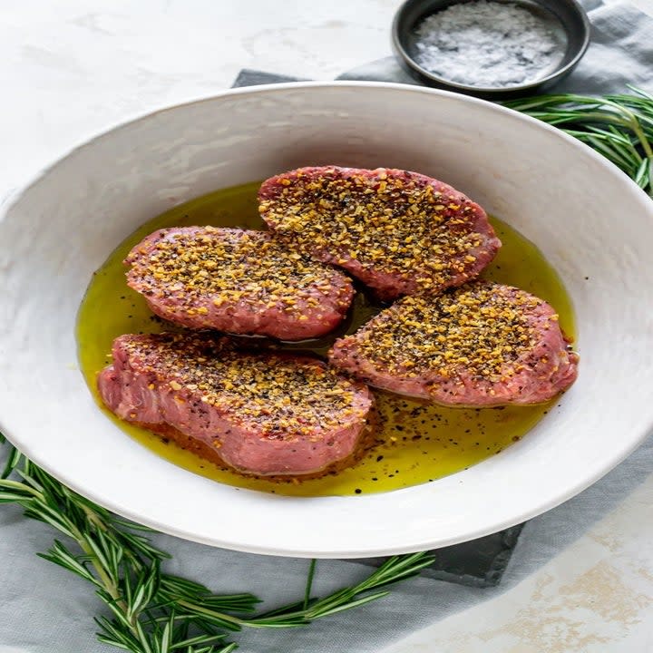 Two fillet mignon steaks marinating.