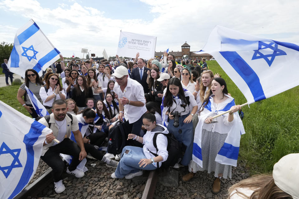 People pose for a photo at the former Nazi German death camp of Auschwitz-Birkenau as they attend the annual Holocaust remembrance event, the "March of the Living" in memory of the six million Holocaust victims in Oswiecim, Poland, Monday, May 6, 2024. The event comes amid the dramatic backdrop of the violence of the Israel-Hamas war after the Oct. 7 Hamas attack, the deadliest violence against Jews since the Holocaust, and as pro-Palestinian protests sweep U.S. campuses. (AP Photo/Czarek Sokolowski)