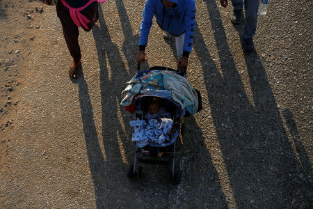 Central American migrants walk during their journey towards the United States, in Mapastepec, Mexico April 20, 2019. REUTERS/Jose Cabezas