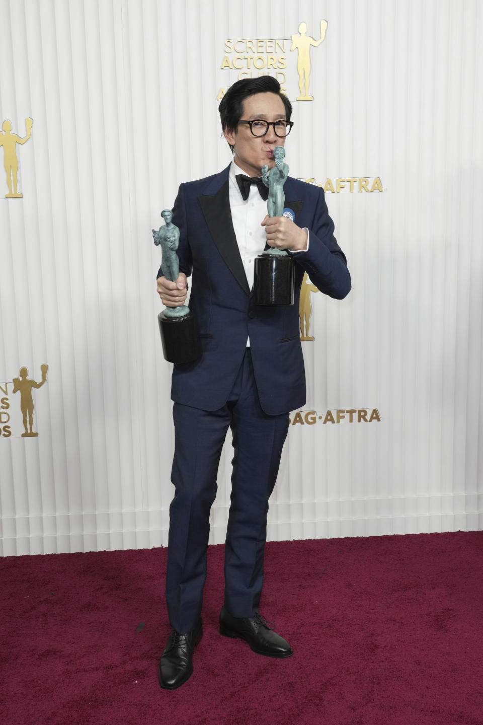 Ke Huy Quan, winner of the award for outstanding performance by a male actor in a supporting role and outstanding performance by a cast in a motion picture for "Everything Everywhere All at Once," poses in the press room at the 29th annual Screen Actors Guild Awards on Sunday, Feb. 26, 2023, at the Fairmont Century Plaza in Los Angeles. (Photo by Jordan Strauss/Invision/AP)