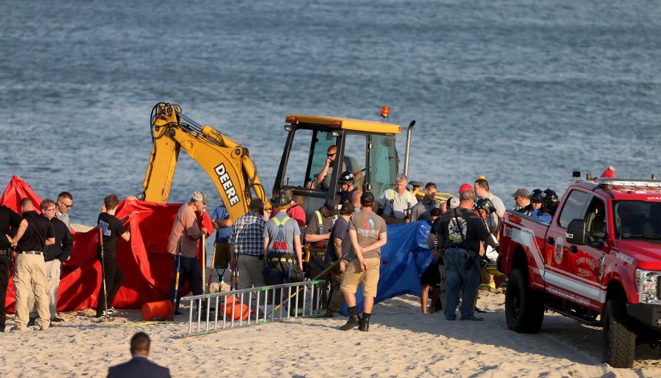 Emergency personnel work to recover a man who was killed in a sand hole collapse at the end of East Bonita Way in the Ocean Beach III section of Toms River Tuesday evening, May 17, 2022.