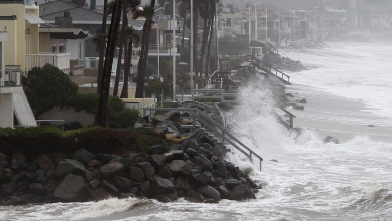 The Pacific Ocean pounds the coast line fronting million-dollar homes in Del Mar, Calif.