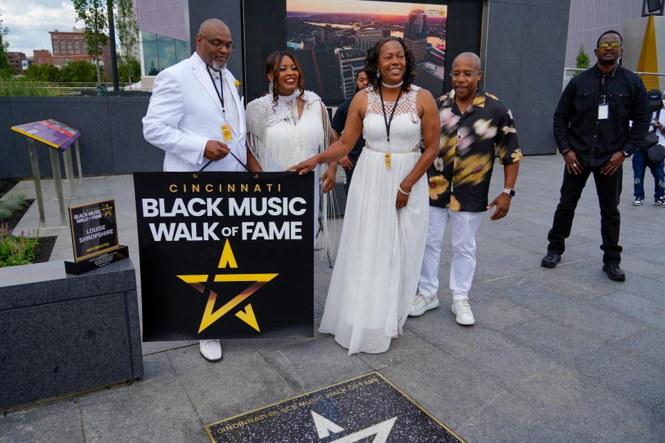 To honor Louise Shropshire, who wrote the lyrics for “We Shall Overcome,” her grandchildren Pastor Robert Shropshire, left, and Michelle Shropshire, second from right, unveil their grandmother’s star at the Black Music Walk of Fame on Saturday