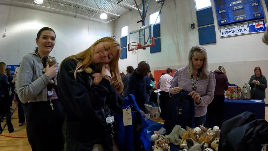 Volunteers were instructed to hug each stuffed animal before placing them inside of the backpack.