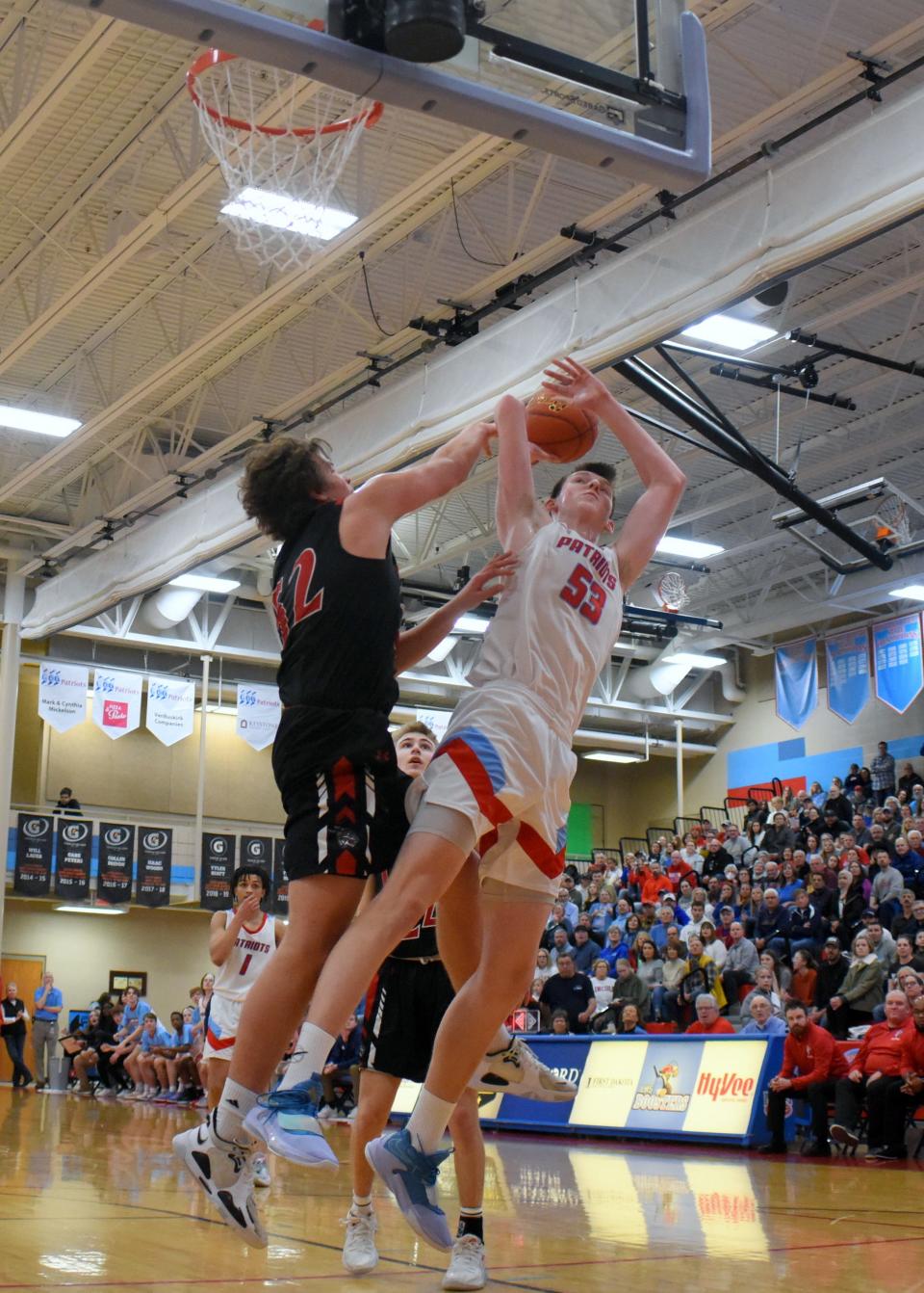 Sioux Falls Lincoln’s JT Rock puts up a shot while being defended by Brandon Valley’s Josh Olthoff on Saturday, March 5, in Sioux Falls.