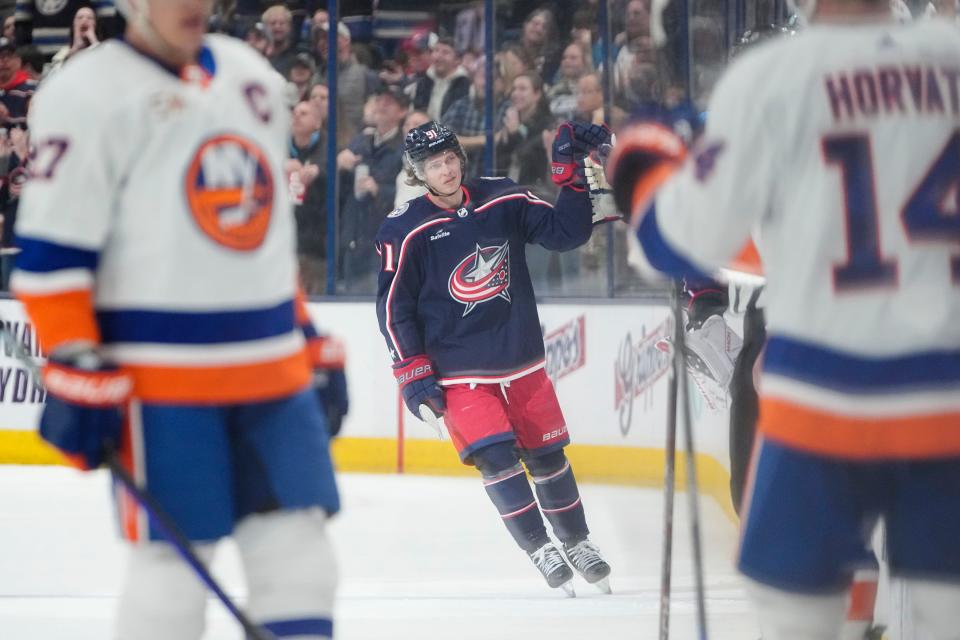 Columbus Blue Jackets center Kent Johnson celebrates scoring a “Michigan goal” during the second period against the New York Islanders at Nationwide Arena. (Adam Cairns, The Columbus Dispatch)