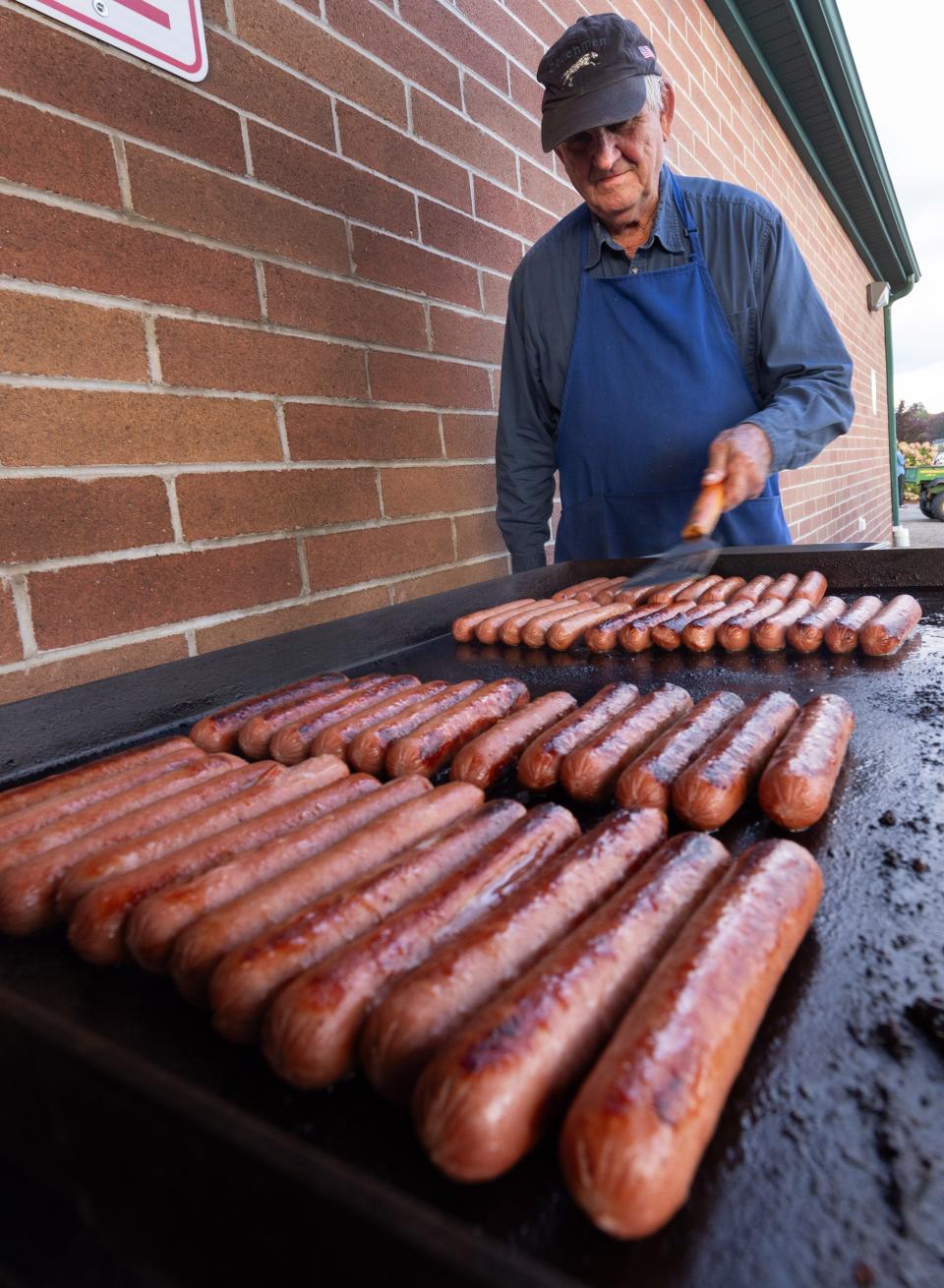 Bob Workinger grills hot dogs at GlenOak stadium before the Sept. 29 football game.