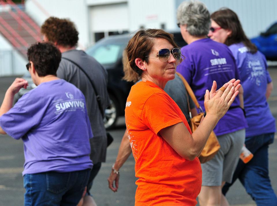 Relay Committee Chair Sunshine Imhoff cheers for cancer survivors as they walk the first lap of Relay for Life following the event’s opening ceremony  Saturday, June 4, 2022 at the Ashland County Fairgrounds. LIZ A. HOSFELD/FOR TIMES-GAZETTE.COM