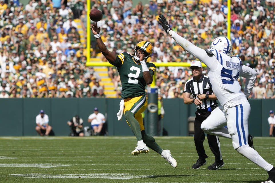 Green Bay Packers quarterback Malik Willis (2) throws on the run as Indianapolis Colts defensive end Dayo Odeyingbo (54) defends during the second half of an NFL football game Sunday, Sept. 15, 2024, in Green Bay, Wis. (AP Photo/Morry Gash)