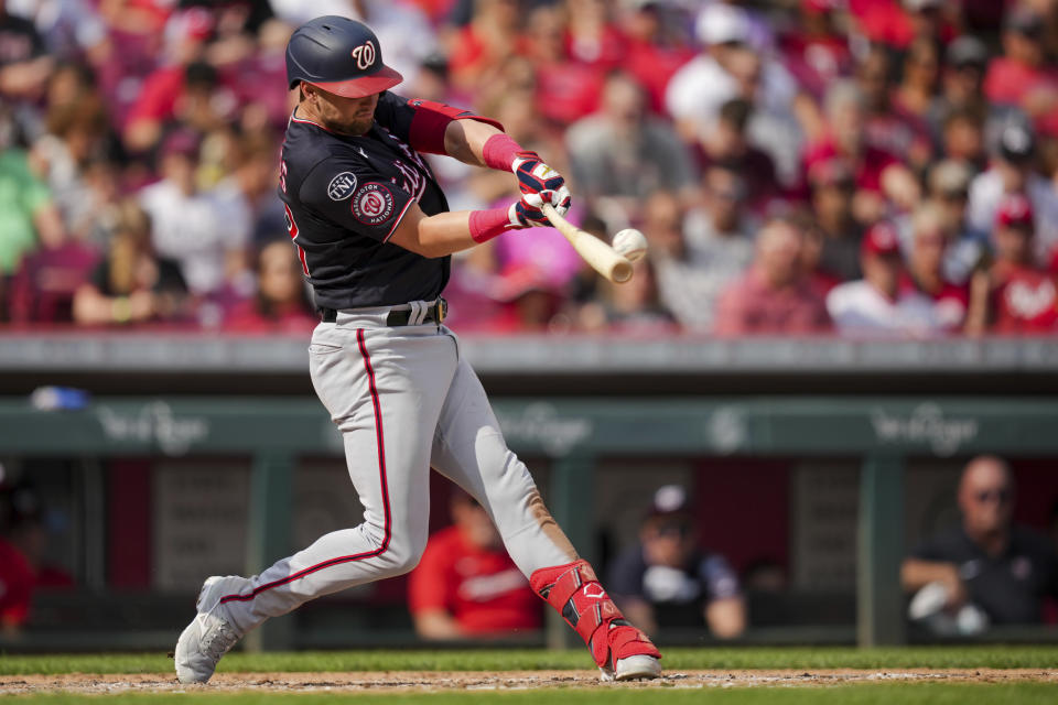 Washington Nationals' Lane Thomas hits an RBI double during the fourth inning of a baseball game against the Cincinnati Reds in Cincinnati, Saturday, Aug. 5, 2022. (AP Photo/Aaron Doster)