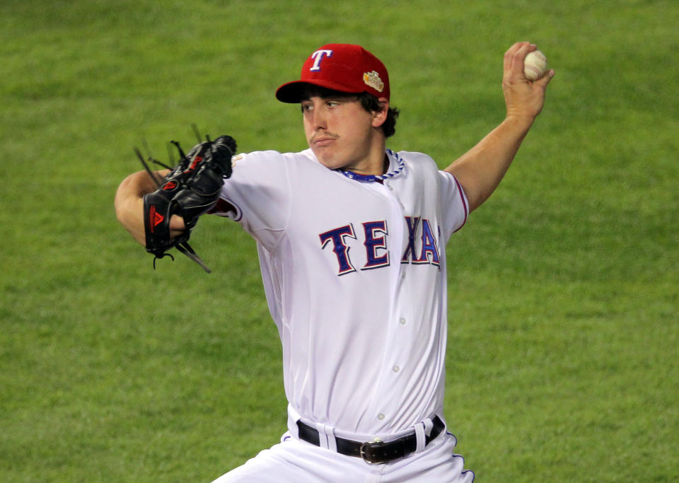 ARLINGTON, TX - OCTOBER 23: Derek Holland #45 of the Texas Rangers pitches in the first inning during Game Four of the MLB World Series against the St. Louis Cardinals at Rangers Ballpark in Arlington on October 23, 2011 in Arlington, Texas. (Photo by Doug Pensinger/Getty Images)