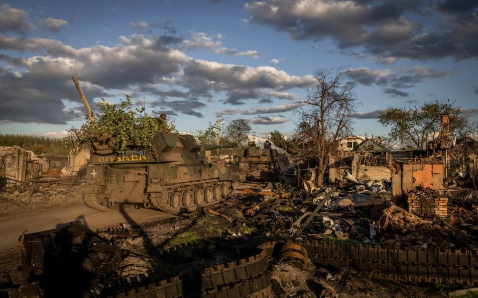 A column of Ukrainian tracked howitzers moves through the recently recaptured village of Yatskivka and toward the front line, in the Donetsk region of Ukraine - Ivor Pickett/New York Times