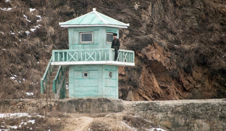 A North Korean soldier stands at a watchtower on the banks of the Yalu River in the town of Sinuiju