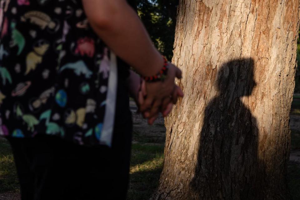 Kari's son, a 17-year-old trans kid, stands alone with his shadow cast upon a tree during golden hour at a park in Georgetown on June 30, 2023. As of September 1 of this year, her son will no longer be legally allowed to have gender affirming healthcare and, according to the bill, will have to be “weaned off” their hormones in a “medically appropriate” manner. “I would love to ask somebody what is going to change between today and next March? Is my son going to magically change genders? Please let me know where that magic is,” Kari said.