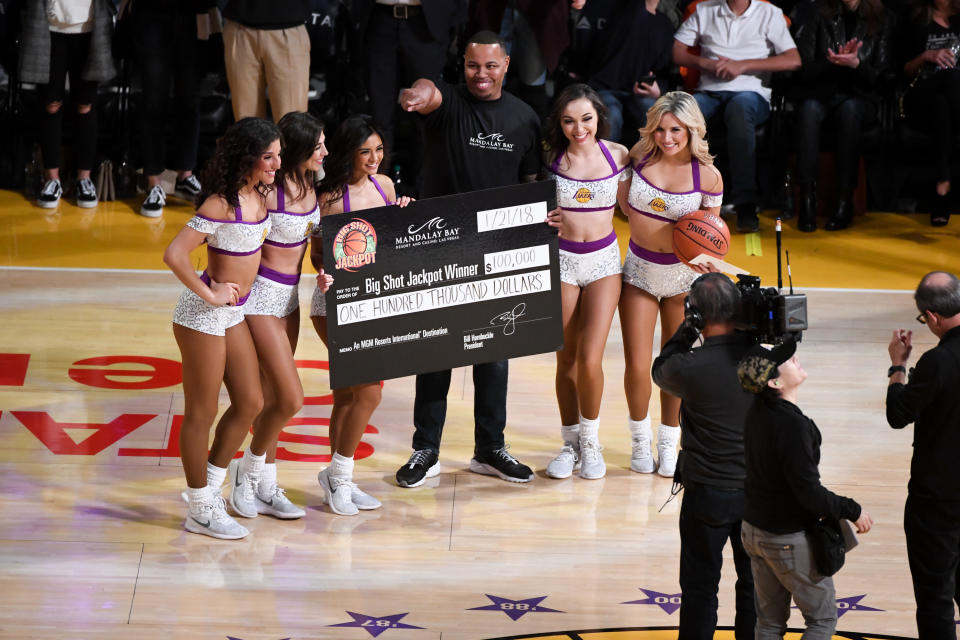 Fan Suni Strong wins the $100,000 Big Shot Jackpot by making a half court shot during Sunday’s game between the Los Angeles Lakers and the New York Knicks. (Getty)