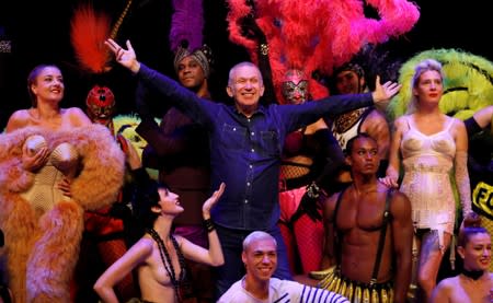 FILE PHOTO: Designer Jean Paul Gaultier poses for a photograph with members of the cast of "Fashion Freak Show" prior to its opening at the Southbank Centre in London