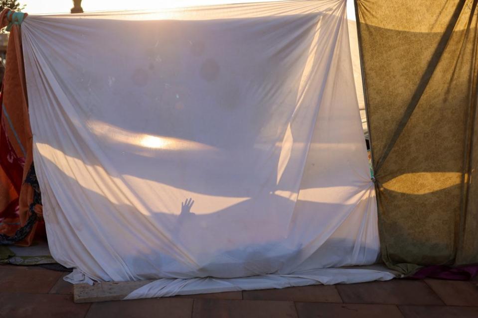 A resident rests in a makeshift shelter on a Marrakech street next to a Gare Routiere in the aftermath of the earthquake on Sept. 10.<span class="copyright">Nacho Doce—Reuters</span>