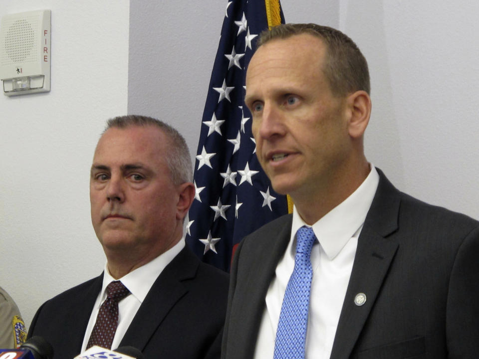 Washoe County District Attorney Chris Hicks, right, answers a reporter's question during a news conference in Reno, Nevada on Monday, Jan. 28, 2019, about murder charges filed against Wilber Martinez-Guzman in the killings of four people in northern Nevada earlier this month as Douglas County District Attorney Mark Jackson looks on. (AP Photo/Scott Sonner)