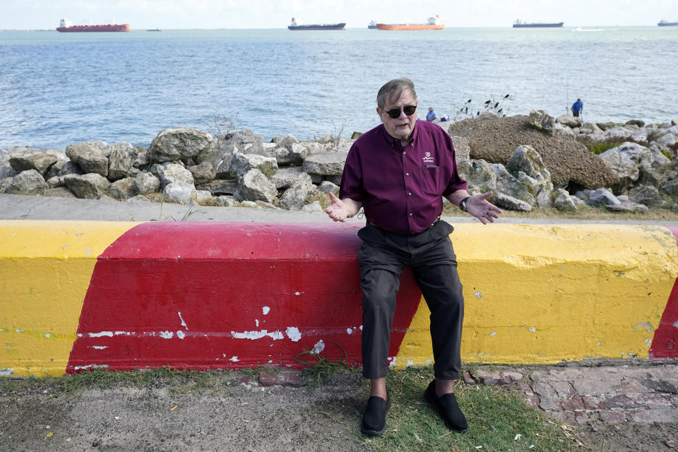 Bill Merrell, a professor in the Marine Sciences Department at Texas A&M University at Galveston and a former president of the school, sits along Galveston Bay as he talks about the Ike Dike project Friday, Sept. 4, 2020, in Galveston, Texas. The Ike Dike is a coastal barrier that, when completed, would protect the Houston-Galveston region including Galveston Bay from hurricane storm surge. The project was conceived by Merrell in response to the extensive surge damage caused by Hurricane Ike in September of 2008. (AP Photo/David J. Phillip)