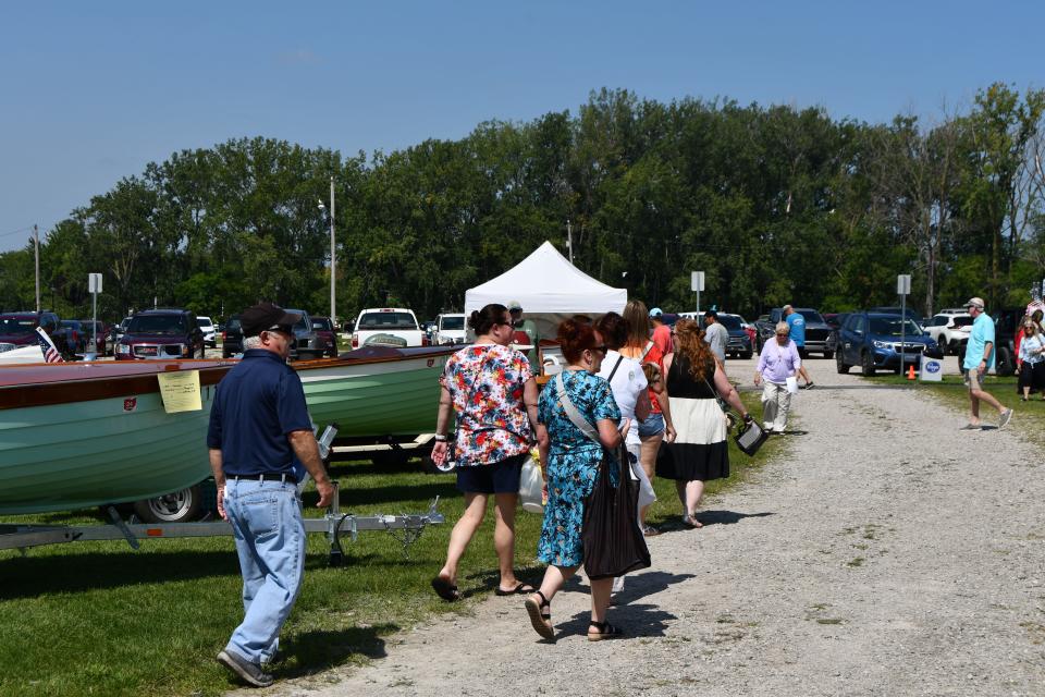 Patrons of the 5th Annual Port Clinton Lighthouse and Maritime Festival check out the antique wooden boats.