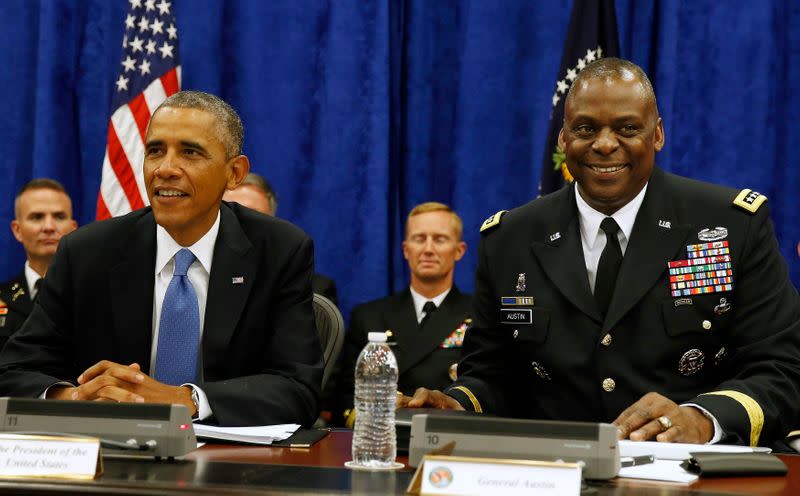 U.S. President Barack Obama sits next to Commander of Central Command Gen. Lloyd Austin III during in a briefing from top military leaders while at U.S. Central Command at MacDill Air Force Base in Tampa