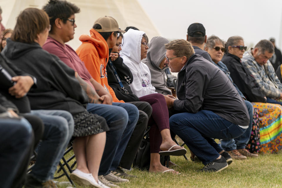 Premier of Saskatchewan Scott Moe speaks with one of the victims' family member during a Federation of Sovereign Indigenous Nations event where leaders provide statements about the mass stabbing incident that happened at James Smith Cree Nation and Weldon, Saskatchewan, Canada, at James Smith Cree Nation, Saskatchewan, Canada, on Thursday, Sept. 8, 2022. (Heywood Yu/The Canadian Press via AP)