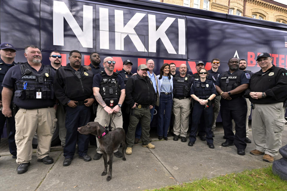 Republican presidential candidate former UN Ambassador Nikki Haley, center, poses for a photo with local law enforcement after a campaign event in Newberry, S.C., Saturday, Feb. 10, 2024. (AP Photo/Matt Kelley)