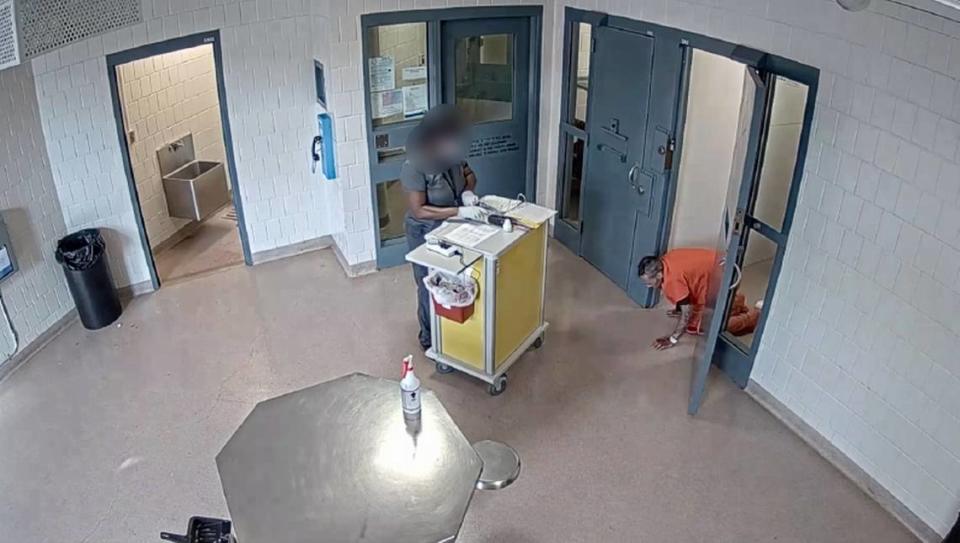Lucas Bellamy crawling on jail cell floor.