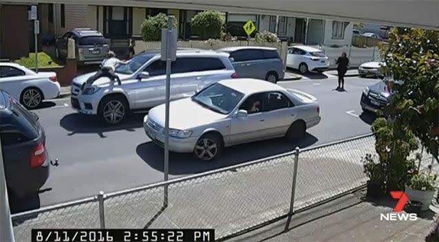 A woman jumped onto the bonnet, as the baby's mum was seen running behind. Picture: 7 News