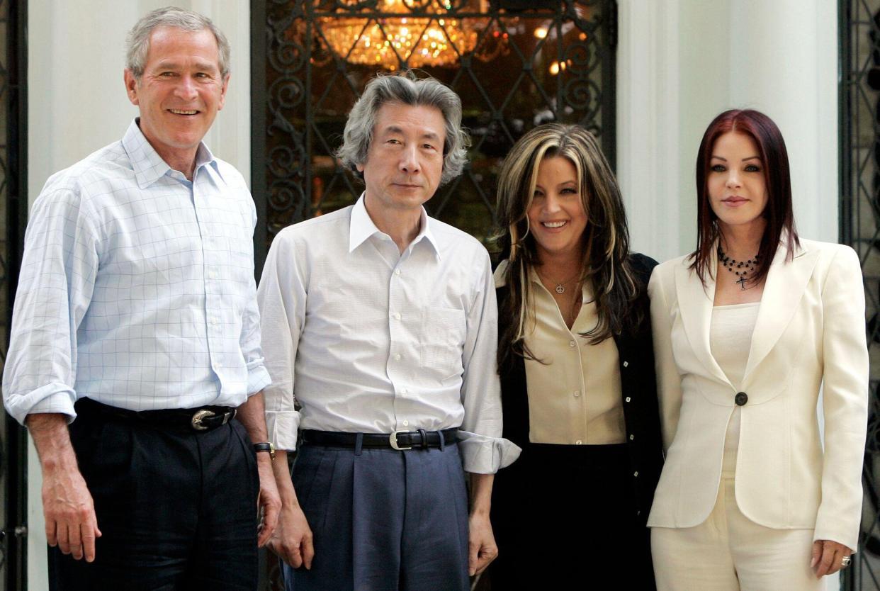 U.S. President George W. Bush (L-R), Japan's Prime Minister Junichiro Koizumi, Lisa Marie Presley and Priscilla Presley stand for photos in front of Elvis Presley's Graceland Mansion in Memphis, Tennessee, June 30, 2006.