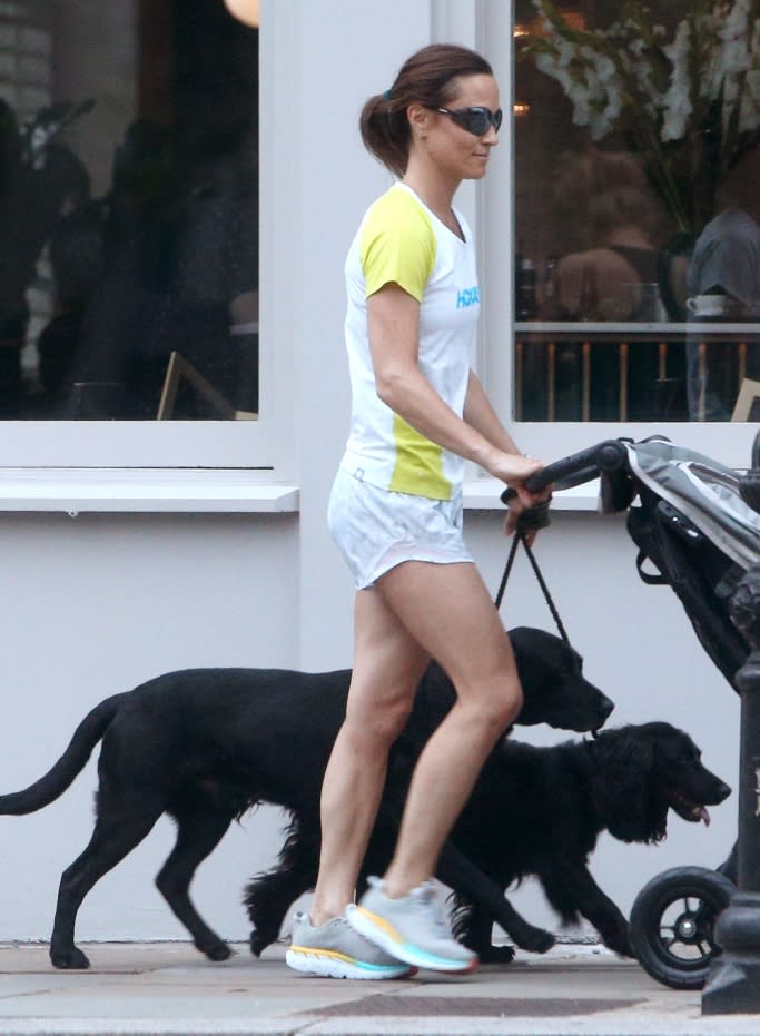 Pippa Middleton wearing Hoka One One sneakers while walking with her son and dogs. - Credit: Shutterstock