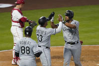 Chicago White Sox's Jose Abreu (79) high-fives Yermin Mercedes (73) after hitting a grand slam during the third inning of an MLB baseball game against the Los Angeles Angels Friday, April 2, 2021, in Anaheim, Calif. Mercedes, Tim Anderson, and Luis Robert (88) also scored. (AP Photo/Ashley Landis)