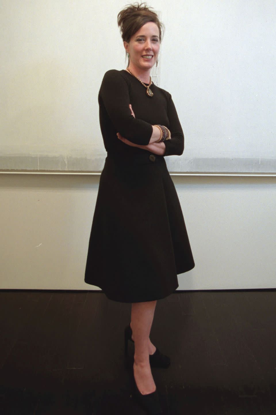 <p>Posing in a black dress, heels, and pendant necklace in 2010.</p>