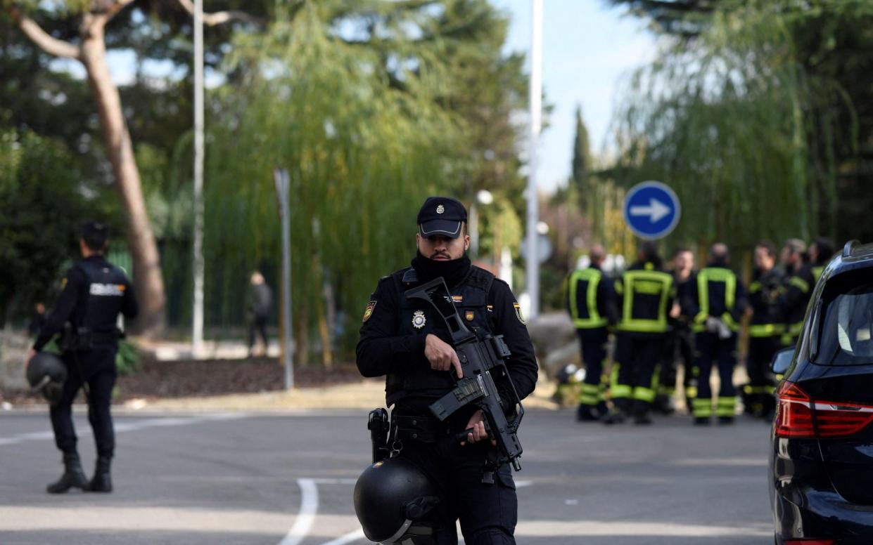 A Spanish policeman near the Ukrainian Embassy in Madrid - OSCAR DEL POZO/AFP via Getty Images