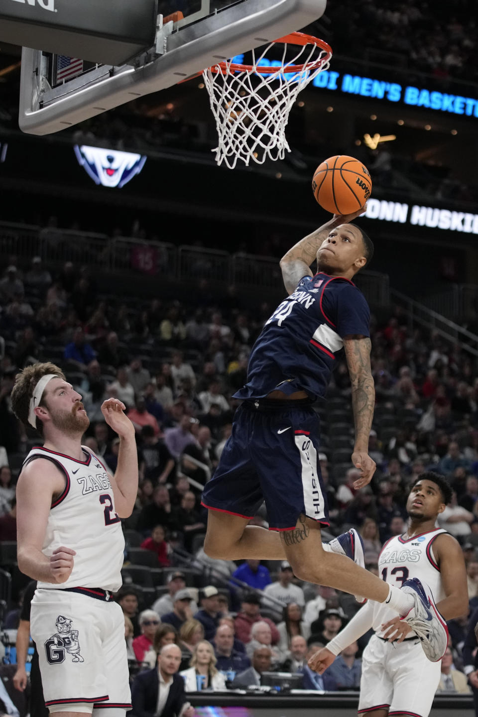 UConn guard Jordan Hawkins goes up for a shot against Gonzaga forward Drew Timme (2), left, in the second half of an Elite 8 college basketball game in the West Region final of the NCAA Tournament, Saturday, March 25, 2023, in Las Vegas. (AP Photo/John Locher)