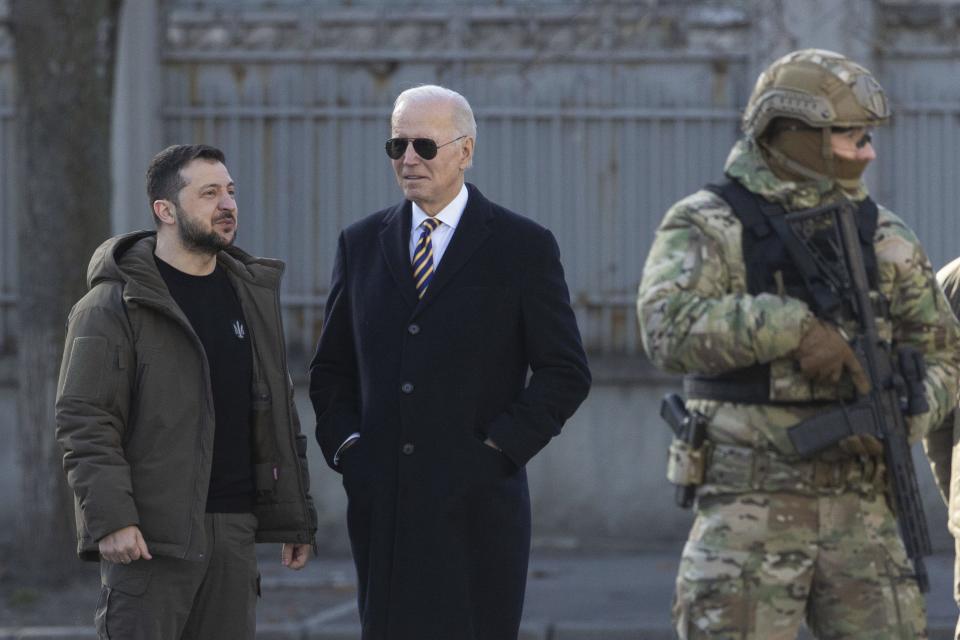 President Joe Biden, center, and Ukrainian President Volodymyr Zelenskyy talk during an unannounced visit in Kyiv, Ukraine, Monday, Feb. 20, 2023. (Ukrainian Presidential Press Office via AP)