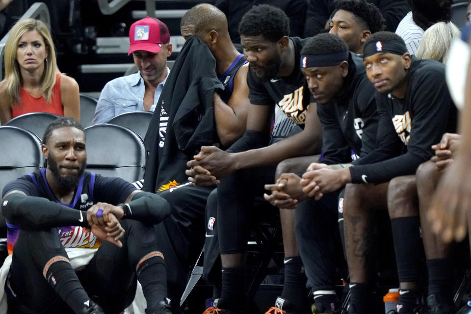 Phoenix Suns players watch from the bench during the second half of Game 7 of an NBA basketball Western Conference playoff semifinal against the Dallas Mavericks, Sunday, May 15, 2022, in Phoenix. The Mavericks defeated the Suns 123-90. (AP Photo/Matt York)