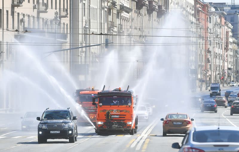 Vehicles spray disinfectant while sanitizing a road amid the outbreak of the coronavirus disease in Moscow