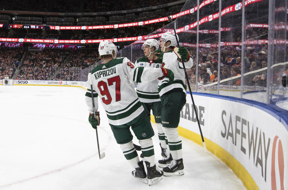 Minnesota Wild's Kirill Kaprizov (97), Matt Boldy (12) and Joel Eriksson Ek (14) celebrate a goal against the Edmonton Oilers during the first period of an NHL hockey game Friday, Feb. 23, 2024, in Edmonton, Alberta. (Jason Franson/The Canadian Press via AP)