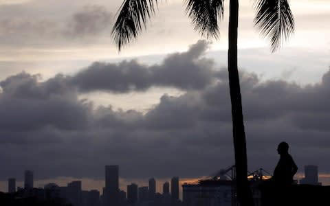  Dark clouds are see over Miami's skyline prior to the arrival of Hurricane Irma to south Florida - Credit: Reuters