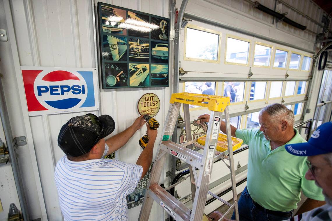 Clint Sullivan helps patrons buy fixtures, menus and merchandise off the walls rom Parkette Drive-In during a sale in Lexington, Ky., Saturday, July 23, 2022.