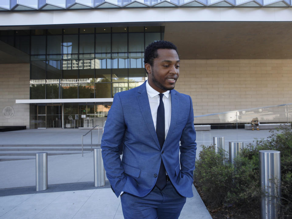 Rapper Marcus Gray leaves the federal courthouse in Los Angeles, Thursday, Aug. 1, 2019. A jury has decided that Katy Perry, her collaborators and her record label must pay more than $2.78 million because the pop star's 2013 hit "Dark Horse" copied a Christian rap song. It was an underdog victory for relatively obscure artist Gray, whose 5-year-old lawsuit survived constant court challenges. Perry’s attorney said they plan to vigorously fight the decision. (AP Photo/Damian Dovarganes)