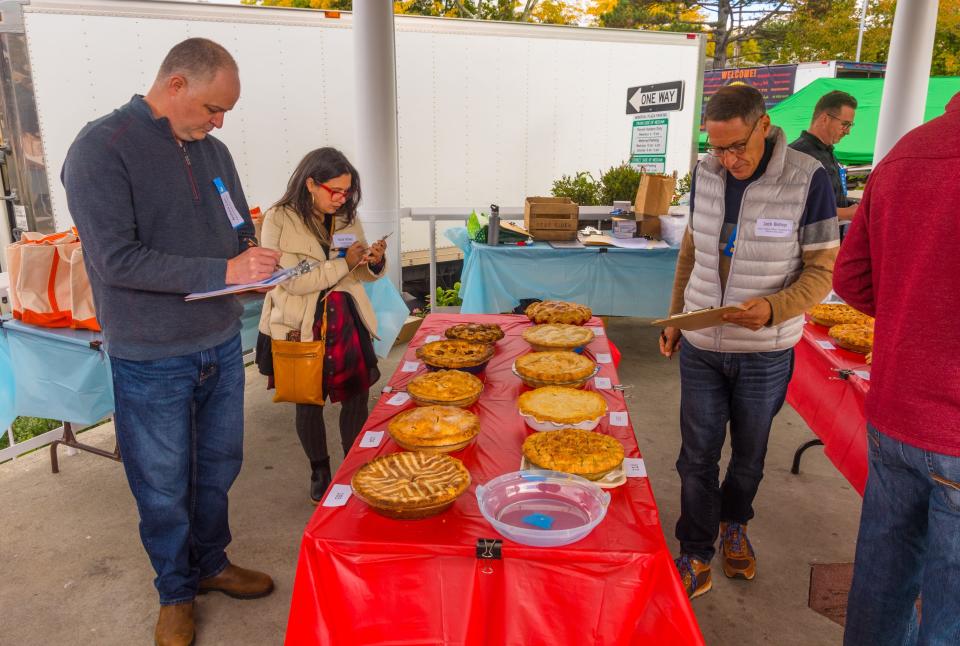 Left to right: Andrew Cain, Head of Culinary at Phelps and Northern Westchester; Suzy Scherr, cookbook author and chef, and Jack Bishop, the chief creative officer of America’s Test Kitchen,review one group of pies for appearance before they are cut (and tasted!) at the Pleasantville Farmers Market annual apple pie contest.