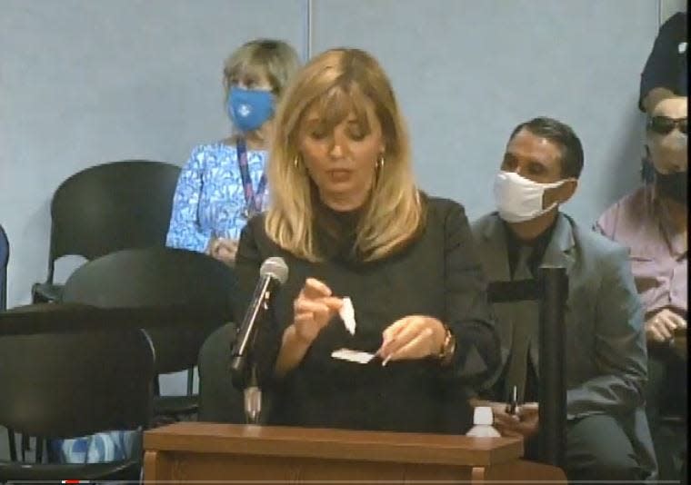 Dr. Belma Andric, Chief Medical Officer for the Health Care District of Palm Beach County, demonstrates a rapid test to be used in public schools. Photo courtesy Palm Beach County School District meeting video.