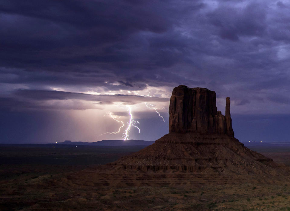 <p>Rain and lightning bolts hammer the desolate terrain of Monument Valley, Arizona. (Photo: Jennifer Khordi/Caters News) </p>