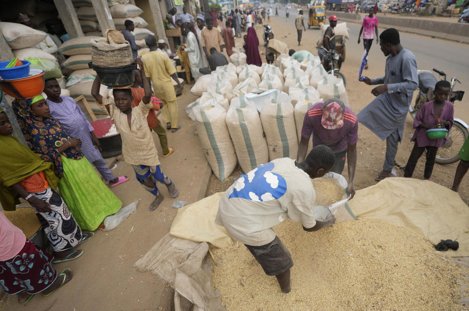 Workers bag grains to sell at the Dawanau International Market in Kano, Nigeria, on Friday, July. 14, 2023. Across the developing world, many countries are fed up with America's dominance of the global financial system — and especially the power of the dollar. (AP Photo/Sunday Alamba)