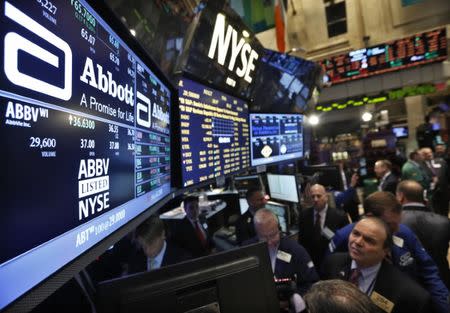 Traders gather at the booth that trades Abbott Laboratories on the floor of the New York Stock Exchange, December 10, 2012. REUTERS/Brendan McDermid/File Photo