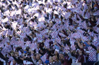 Colorado Rapids fans wave flags to welcome their team to the pitch to face the Portland Timbers before an MLS Western Conference semifinal playoff soccer match Thursday, Nov. 25, 2021, in Commerce City, Colo. (AP Photo/David Zalubowski)