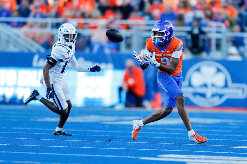 Boise State wide receiver Cameron Camper (9) turns to catch the ball in front of Utah State cornerback Avante Dickerson (17) in the first half of an NCAA college football game, Saturday, Oct. 5, 2024, in Boise, Idaho. . (AP Photo/Steve Conner) | Steve Conner